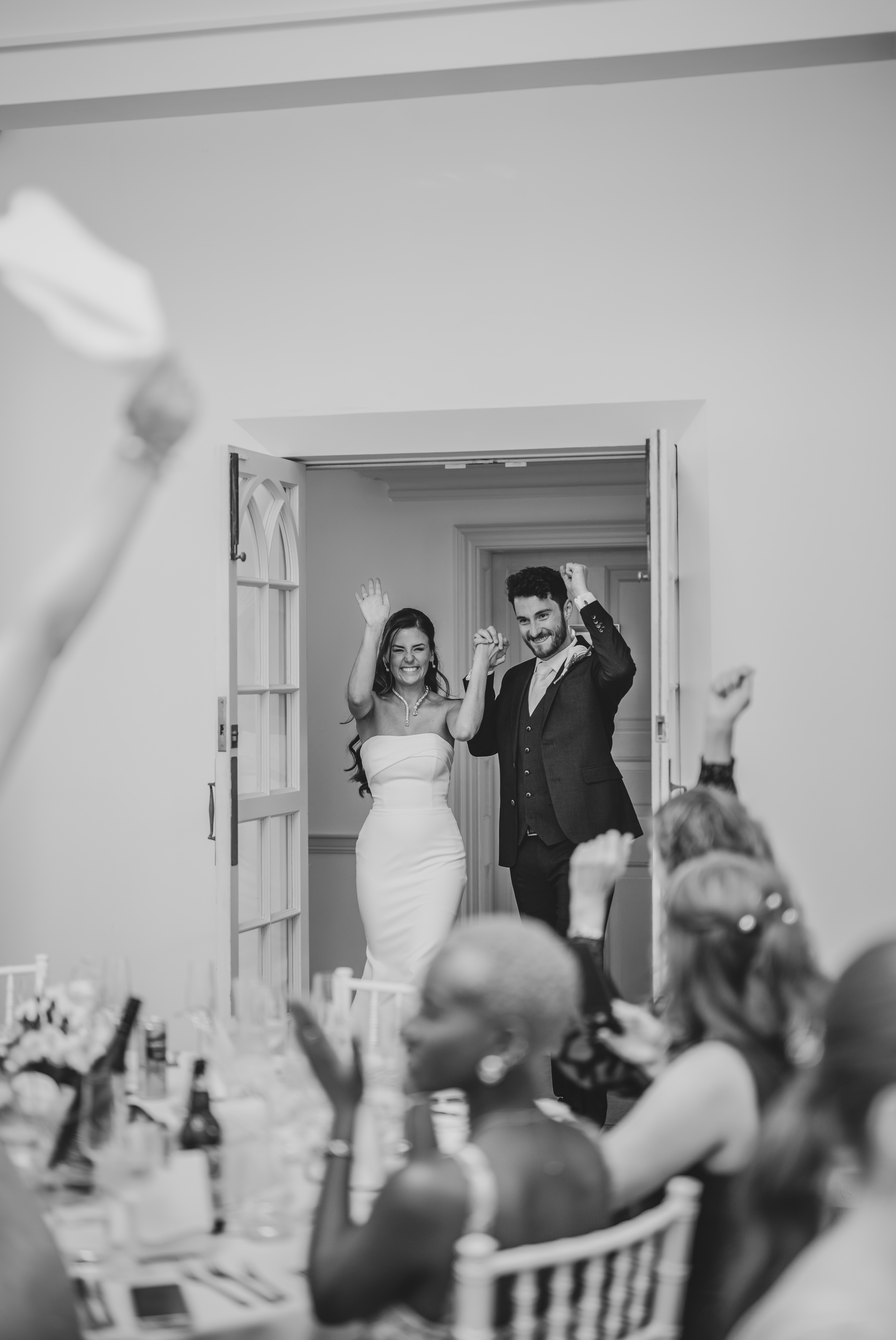 Joyful photograph of Bride & Groom entrance to wedding breakfast at Penn Castle Estate
